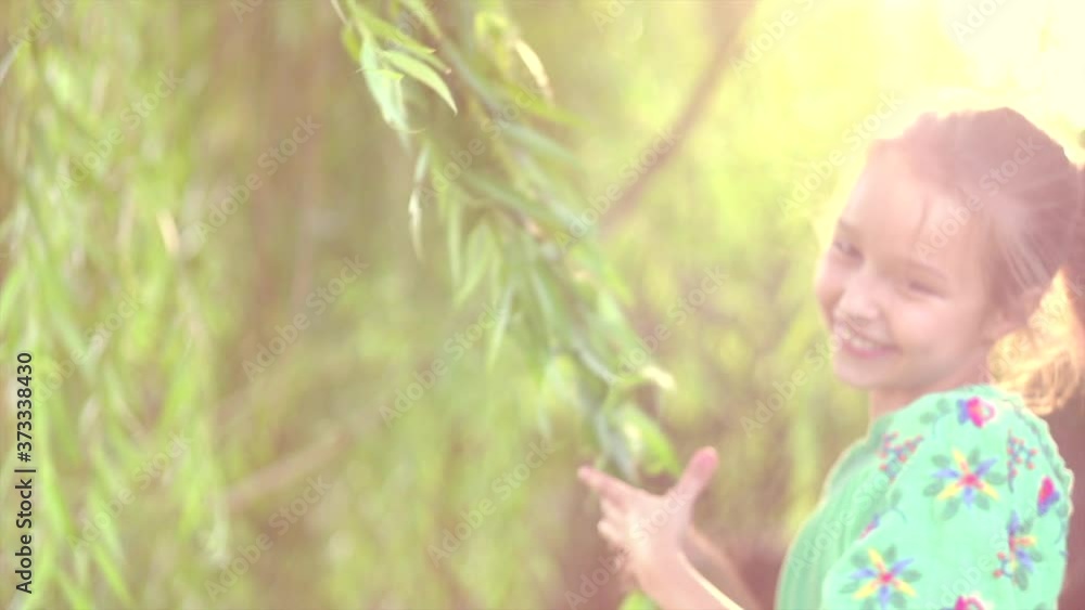 Happy child having fun outdoor. Little girl with long hair laughing in a spring park, enjoying nature, spinning and smiling. Slow motion 4K UHD Happy child having fun outdoor. Little girl with long hair laughing in a spring park, enjoying nature, spinning and smiling. Slow motion 4K UHD