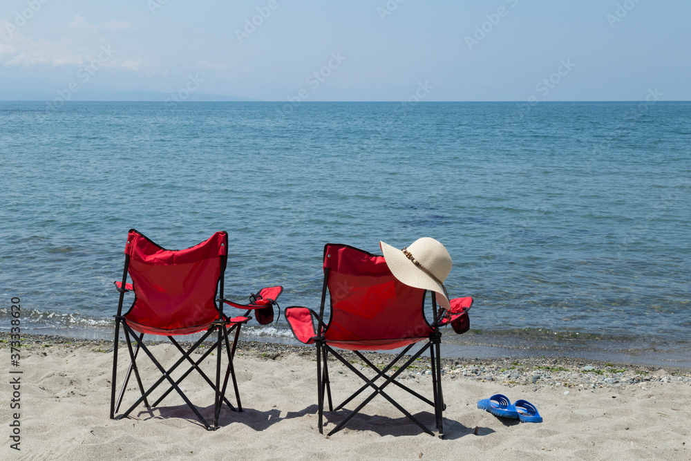 Red camp comfortable chair near the seaside. A beautiful sea view from Black sea Turkey. Red camp comfortable chair near the seaside. A beautiful sea view from Black sea Turkey.