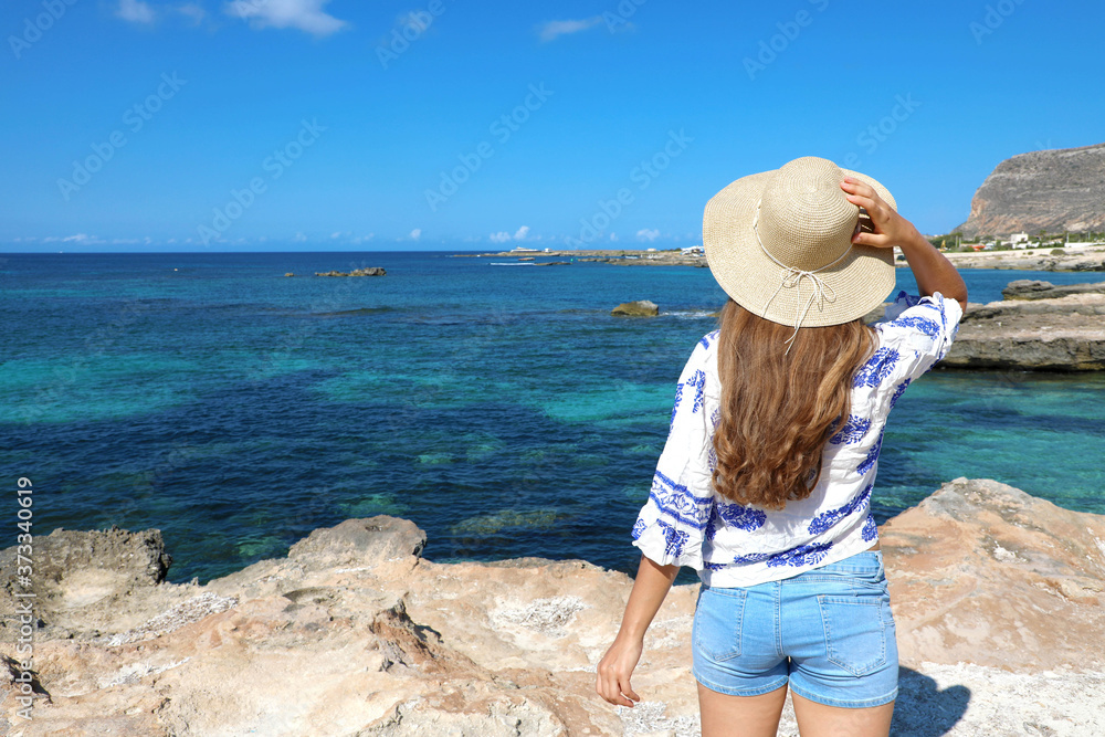 Beautiful traveler girl in Sicily. Young woman enjoying holidays in Favignana Island in Italy.