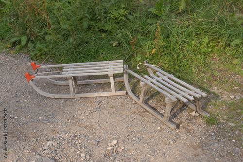 two wooden sleds on a path