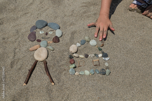 Making people with stones at the beach for children activity time.