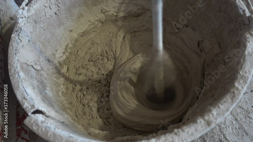 Construction mixer in a bucket with plaster