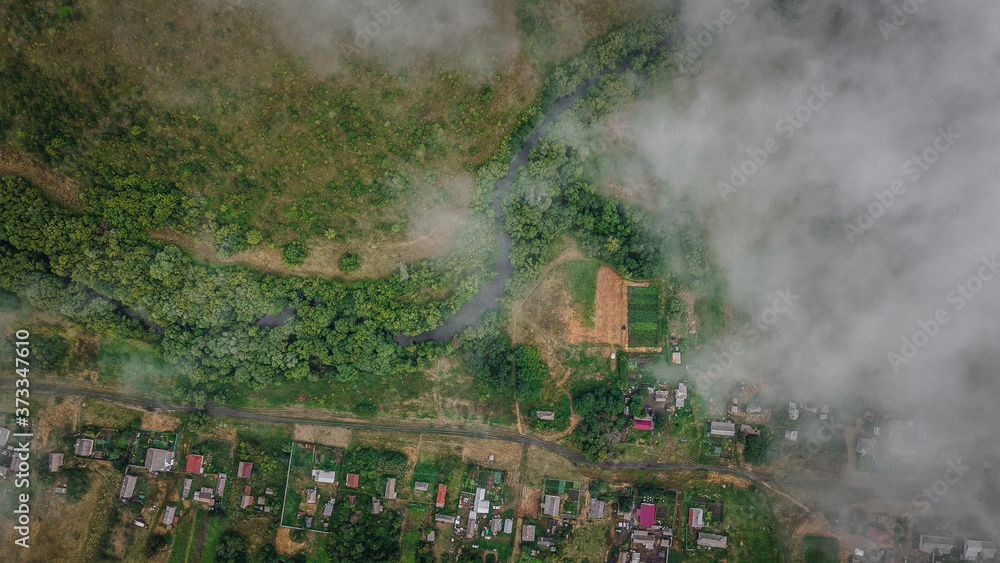 Fototapeta premium forest village snapshot from behind the clouds. Russian Federation