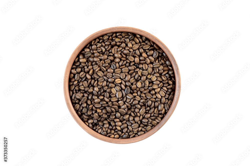 Coffee beans in a small clay pan carved on a white background. The concept of selected raw materials for making coffee. Coffee beans in a small clay pan carved on a white background. The concept of selected raw materials for making coffee.