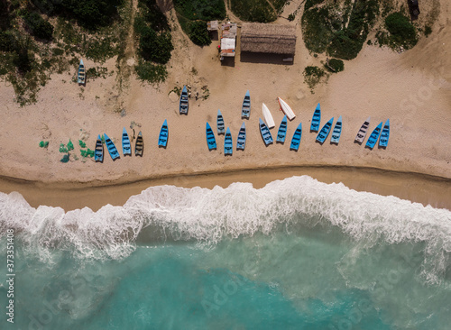 Aerial drone view of fisherman's boats on the beach of Caribbean Sea in Los Patos, Barahona, Dominican Republic 