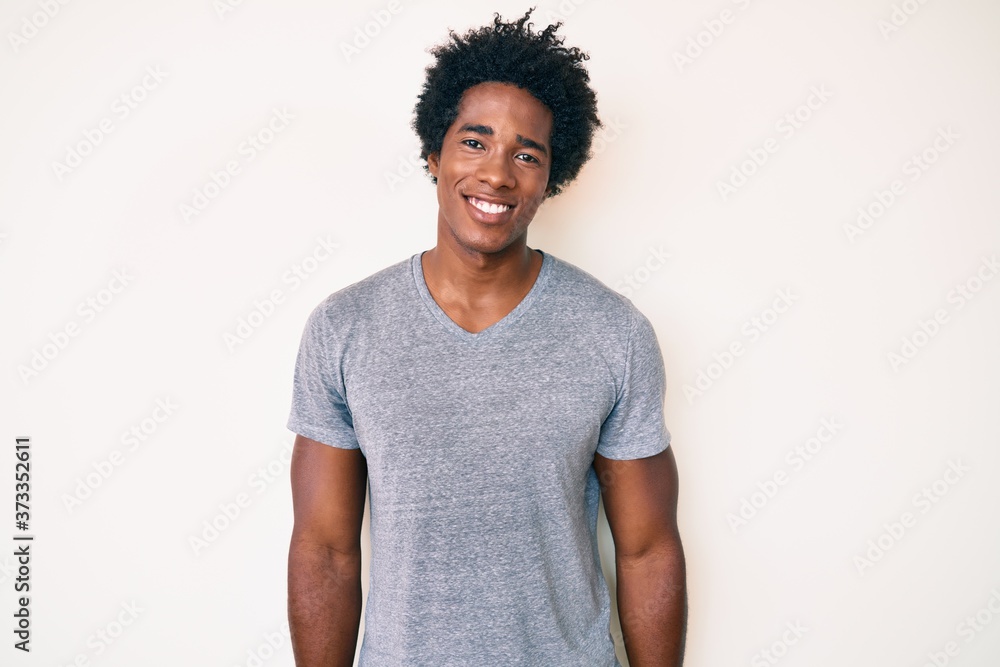 Handsome african american man with afro hair wearing casual clothes with a happy and cool smile on face. lucky person. Handsome african american man with afro hair wearing casual clothes with a happy and cool smile on face. lucky person.