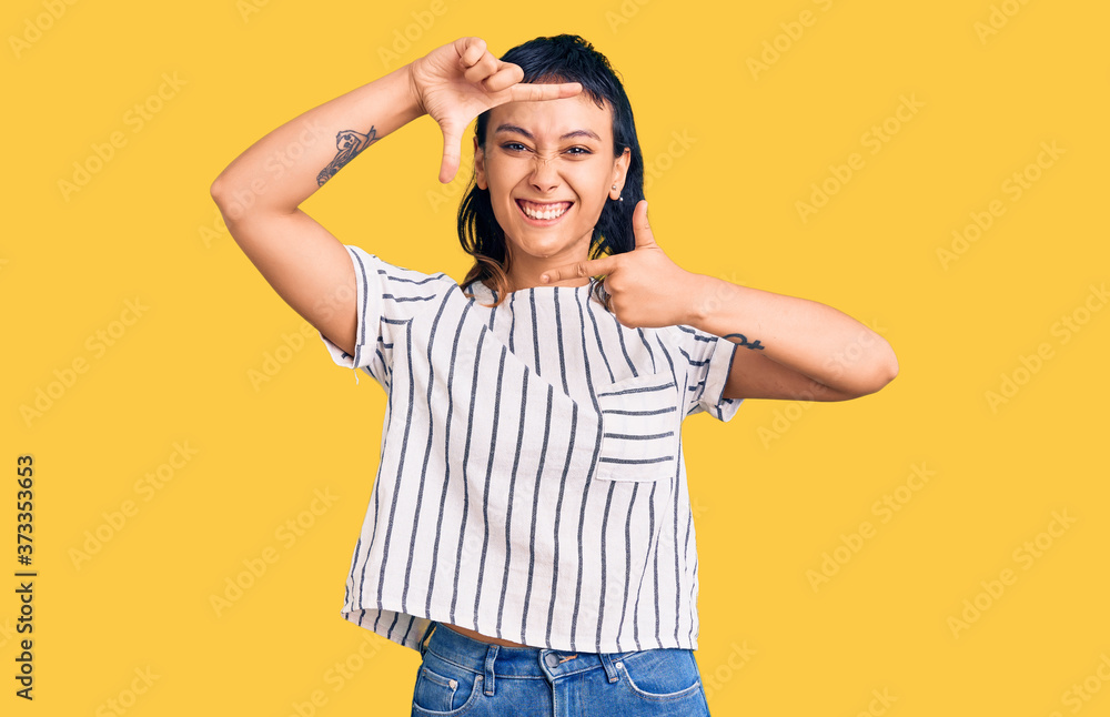 Young woman wearing casual clothes smiling making frame with hands and fingers with happy face. creativity and photography concept. Young woman wearing casual clothes smiling making frame with hands and fingers with happy face. creativity and photography concept.