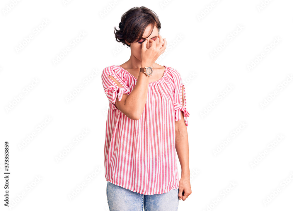 Beautiful young woman with short hair wearing casual summer clothes tired rubbing nose and eyes feeling fatigue and headache. stress and frustration concept. Beautiful young woman with short hair wearing casual summer clothes tired rubbing nose and eyes feeling fatigue and headache. stress and frustration concept.