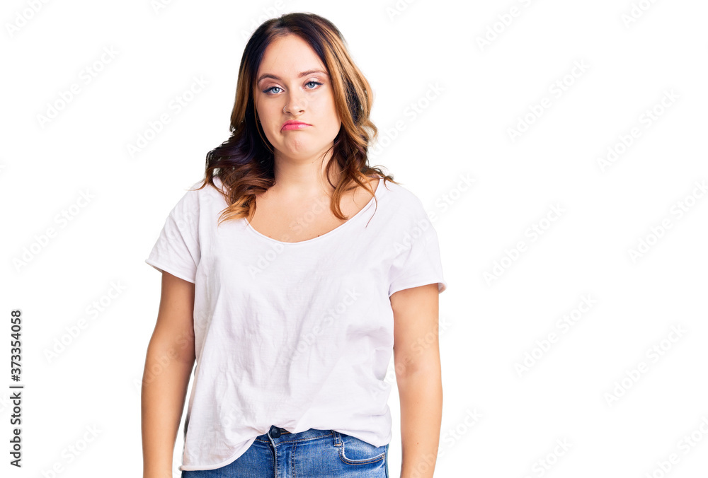 Fototapeta premium Young beautiful caucasian woman wearing casual white tshirt looking sleepy and tired, exhausted for fatigue and hangover, lazy eyes in the morning.