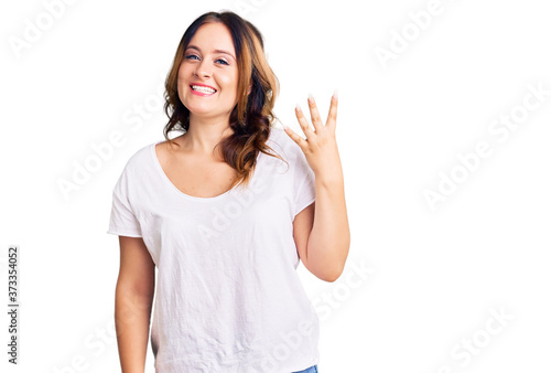 Wallpaper Mural Young beautiful caucasian woman wearing casual white tshirt showing and pointing up with fingers number four while smiling confident and happy. Torontodigital.ca