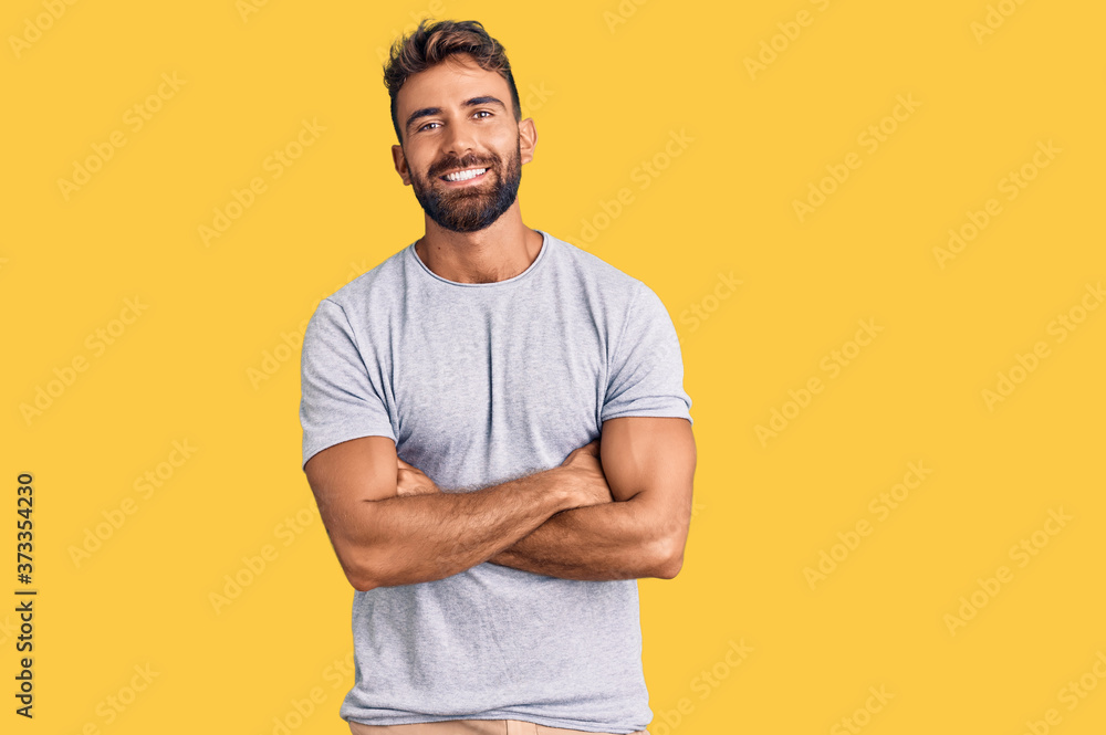 Young hispanic man wearing casual clothes happy face smiling with crossed arms looking at the camera. positive person. - obrazy, fototapety, plakaty 