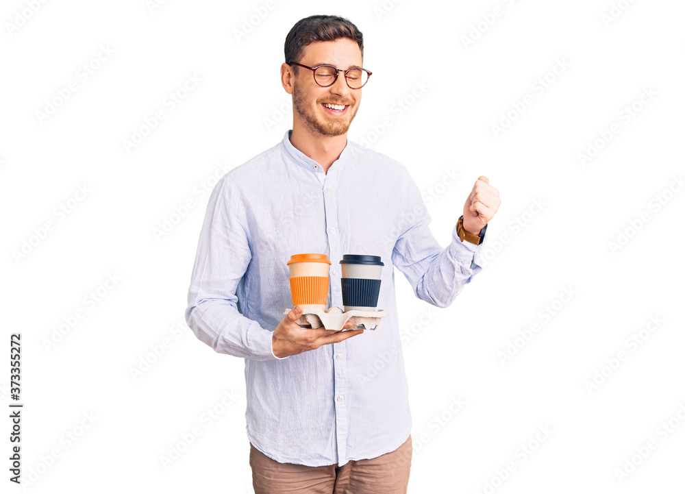 Handsome young man with bear holding takeaway cup of coffee screaming proud, celebrating victory and success very excited with raised arms Handsome young man with bear holding takeaway cup of coffee screaming proud, celebrating victory and success very excited with raised arms