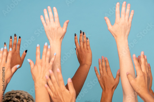Hands of large group of women of various ethnicities with white and dark skin