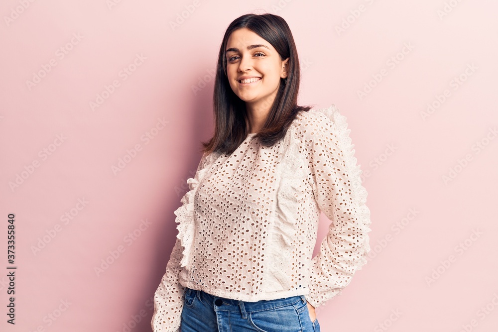 Young beautiful girl wearing casual clothes smiling happy and confident. Standing with smile on face over isolated pink background Young beautiful girl wearing casual clothes smiling happy and confident. Standing with smile on face over isolated pink background