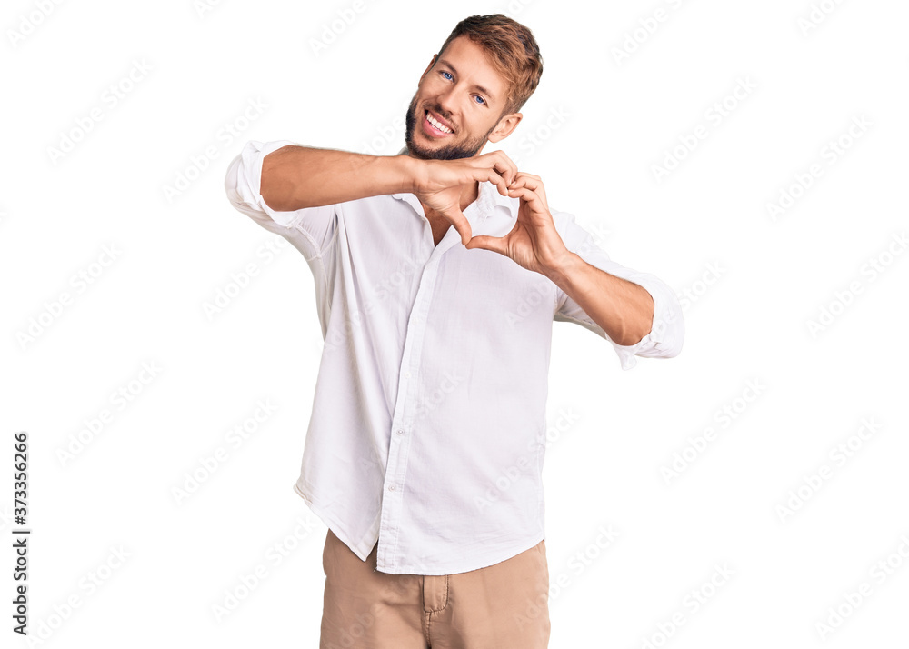 Young caucasian man wearing casual clothes smiling in love doing heart symbol shape with hands. romantic concept. Young caucasian man wearing casual clothes smiling in love doing heart symbol shape with hands. romantic concept.