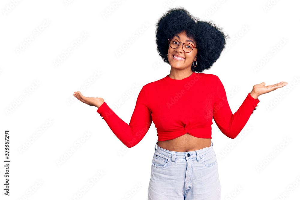 Young african american girl wearing casual clothes and glasses smiling showing both hands open palms, presenting and advertising comparison and balance Young african american girl wearing casual clothes and glasses smiling showing both hands open palms, presenting and advertising comparison and balance