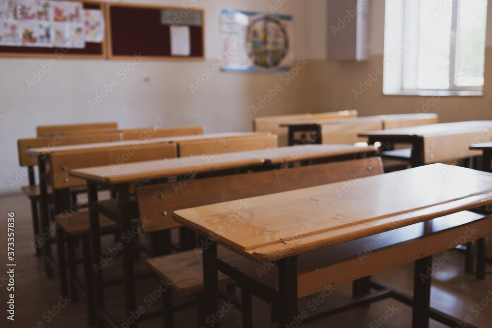 Tables and desks in empty non-student classroom