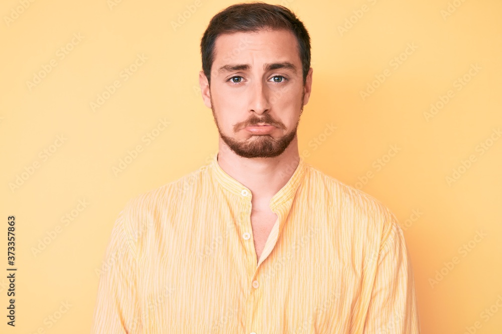Young handsome man wearing casual clothes depressed and worry for distress, crying angry and afraid. sad expression. Young handsome man wearing casual clothes depressed and worry for distress, crying angry and afraid. sad expression.