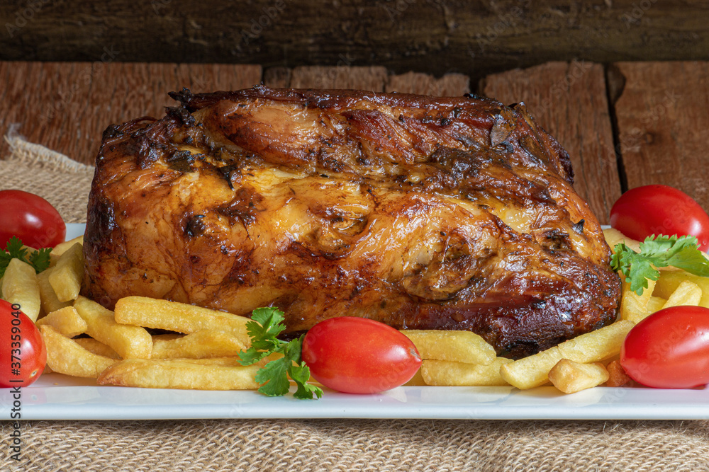 Juicy roast meat on a rustic wooden background. Juicy roast meat on a rustic wooden background.