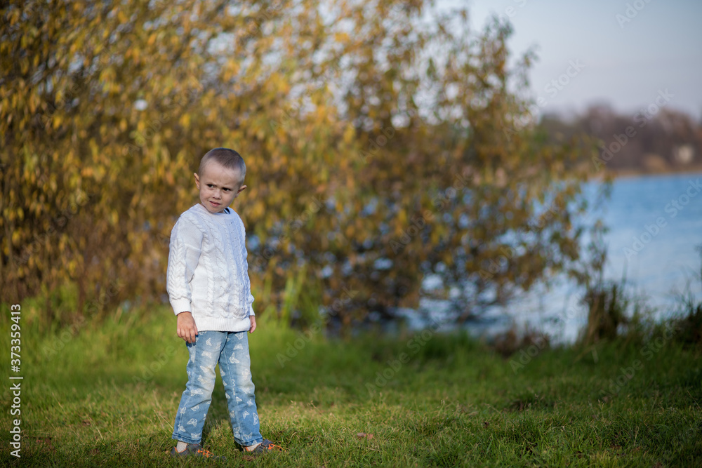 .A girl with a short haircut in a white knitted sweater looks to the side .A girl with a short haircut in a white knitted sweater looks to the side