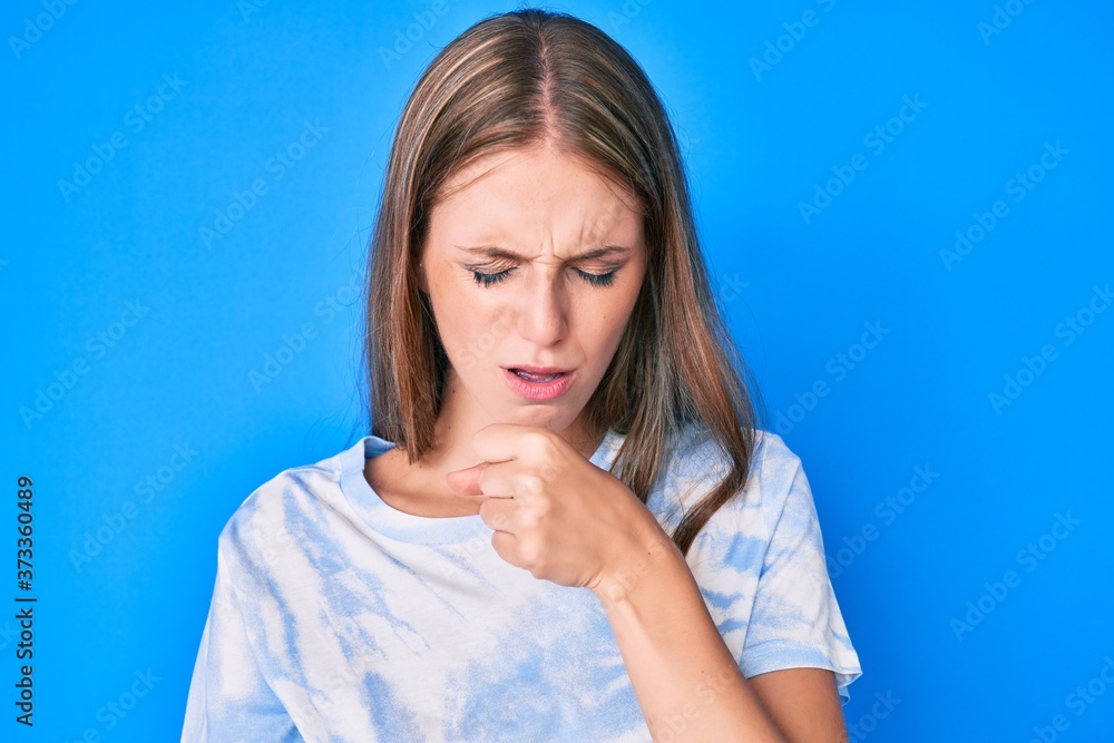 Young blonde girl wearing casual clothes feeling unwell and coughing as symptom for cold or bronchitis. health care concept.
