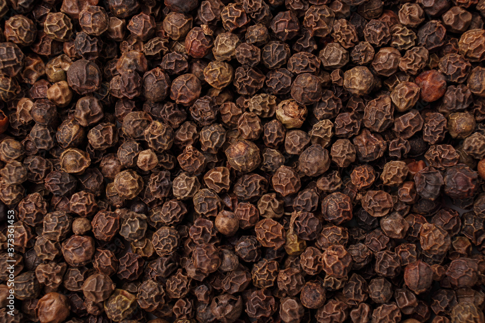 Pile of black peppercorns as background, top view, close up. Pile of black peppercorns as background, top view, close up.