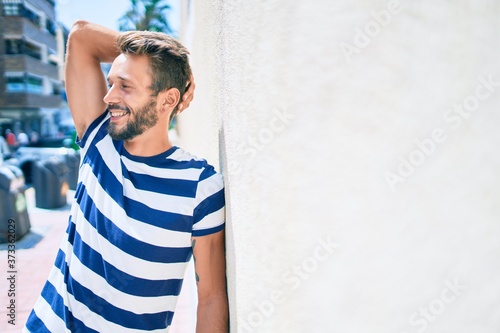 Handsome caucasian man with beard smiling happy outdoors