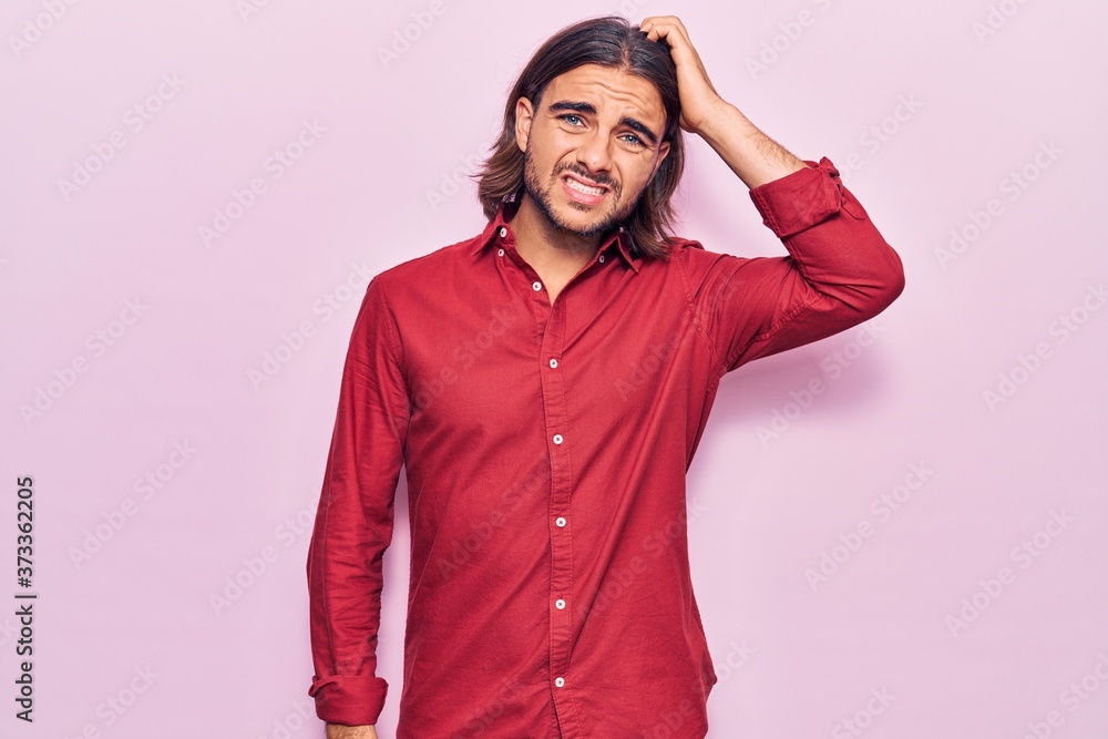 Fototapeta premium Young handsome man wearing business clothes confuse and wonder about question. uncertain with doubt, thinking with hand on head. pensive concept.
