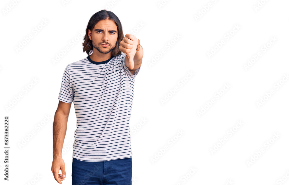 Fototapeta premium Young handsome man wearing casual clothes looking unhappy and angry showing rejection and negative with thumbs down gesture. bad expression.