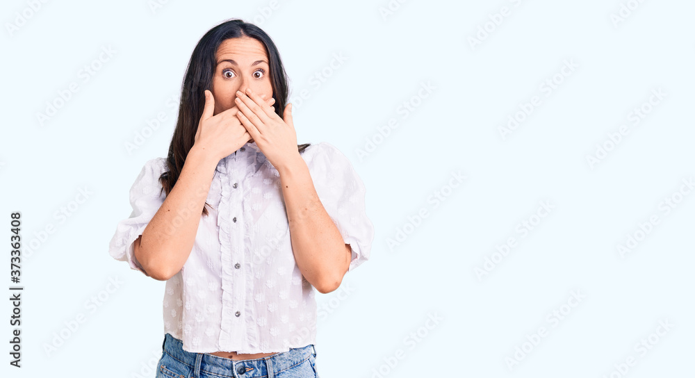 Young beautiful brunette woman wearing casual shirt shocked covering mouth with hands for mistake. secret concept. Young beautiful brunette woman wearing casual shirt shocked covering mouth with hands for mistake. secret concept.