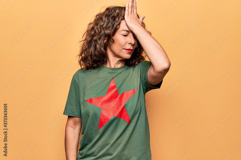 Middle age beautiful woman wearing t-shirt with red star revolutionary symbol of communism surprised with hand on head for mistake, remember error. Forgot, bad memory concept. Middle age beautiful woman wearing t-shirt with red star revolutionary symbol of communism surprised with hand on head for mistake, remember error. Forgot, bad memory concept.