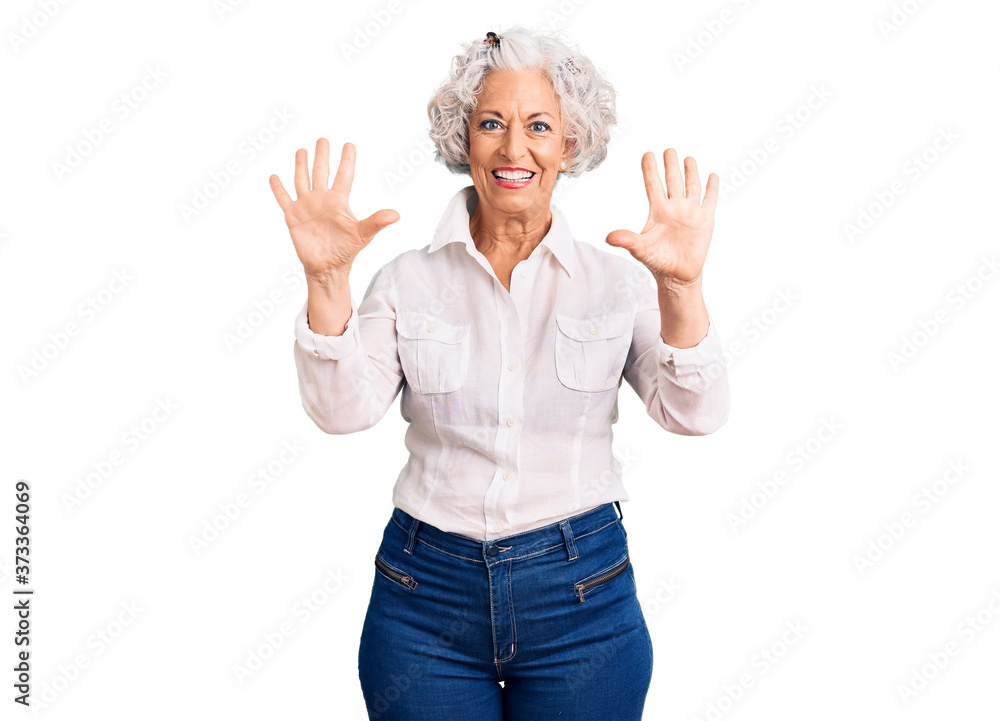 Senior grey-haired woman wearing casual clothes showing and pointing up with fingers number ten while smiling confident and happy. Senior grey-haired woman wearing casual clothes showing and pointing up with fingers number ten while smiling confident and happy.