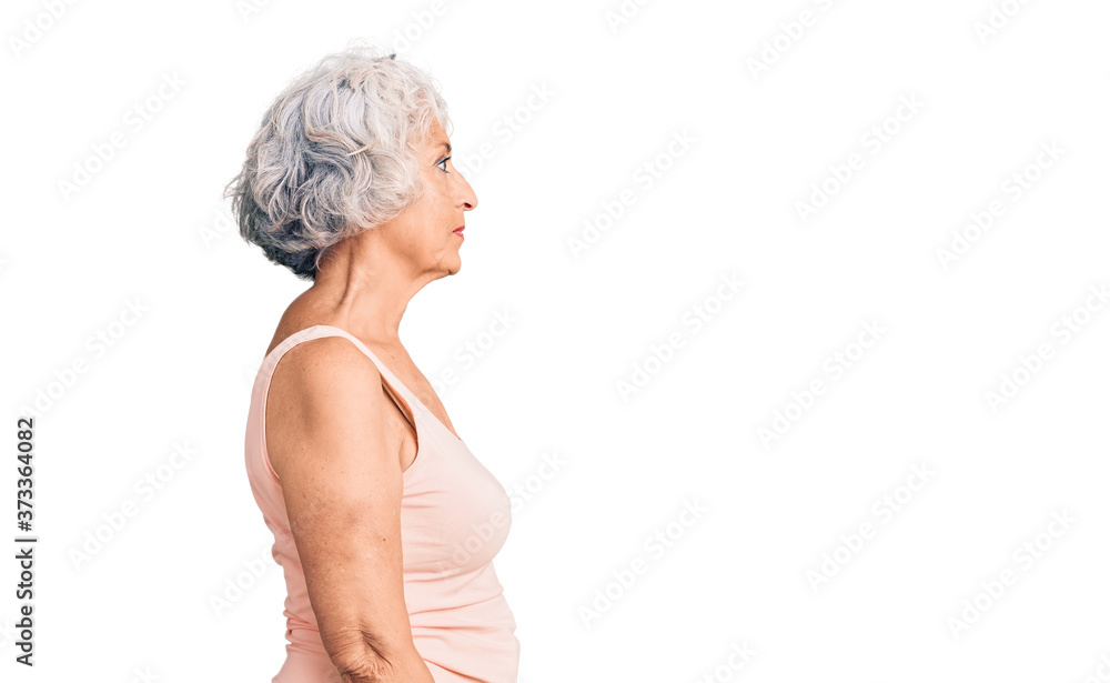 Senior grey-haired woman wearing casual clothes looking to side, relax profile pose with natural face with confident smile. Senior grey-haired woman wearing casual clothes looking to side, relax profile pose with natural face with confident smile.