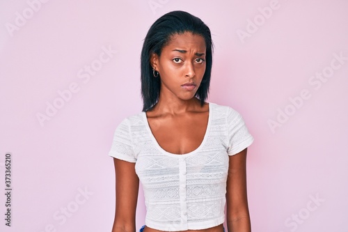 Young african american woman wearing casual clothes skeptic and nervous, frowning upset because of problem. negative person.