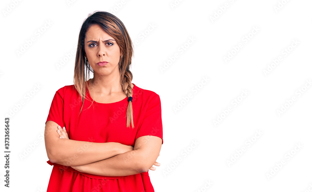 Young beautiful woman wearing casual t-shirt skeptic and nervous, disapproving expression on face with crossed arms. negative person. Young beautiful woman wearing casual t-shirt skeptic and nervous, disapproving expression on face with crossed arms. negative person.