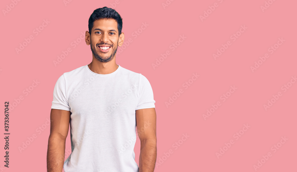 Young latin man wearing casual clothes with a happy and cool smile on face. lucky person. Young latin man wearing casual clothes with a happy and cool smile on face. lucky person.