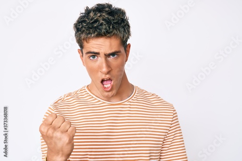 Wallpaper Mural Young handsome man wearing casual clothes angry and mad raising fist frustrated and furious while shouting with anger. rage and aggressive concept. Torontodigital.ca