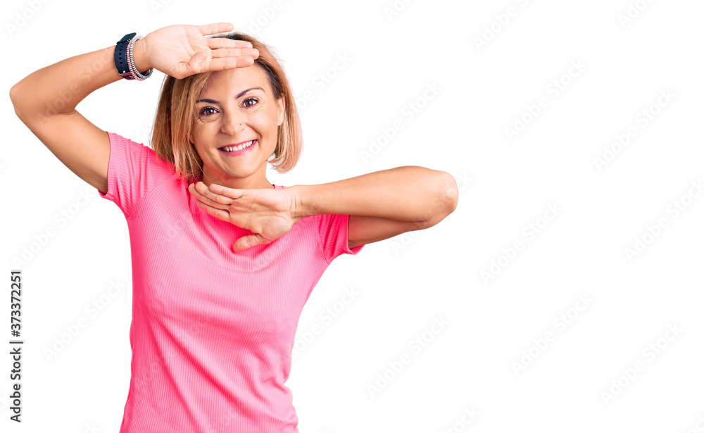 Fototapeta premium Young blonde woman wearing sportswear smiling cheerful playing peek a boo with hands showing face. surprised and exited