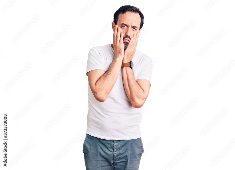 Middle age handsome man wearing casual t-shirt tired hands covering face, depression and sadness, upset and irritated for problem Middle age handsome man wearing casual t-shirt tired hands covering face, depression and sadness, upset and irritated for problem