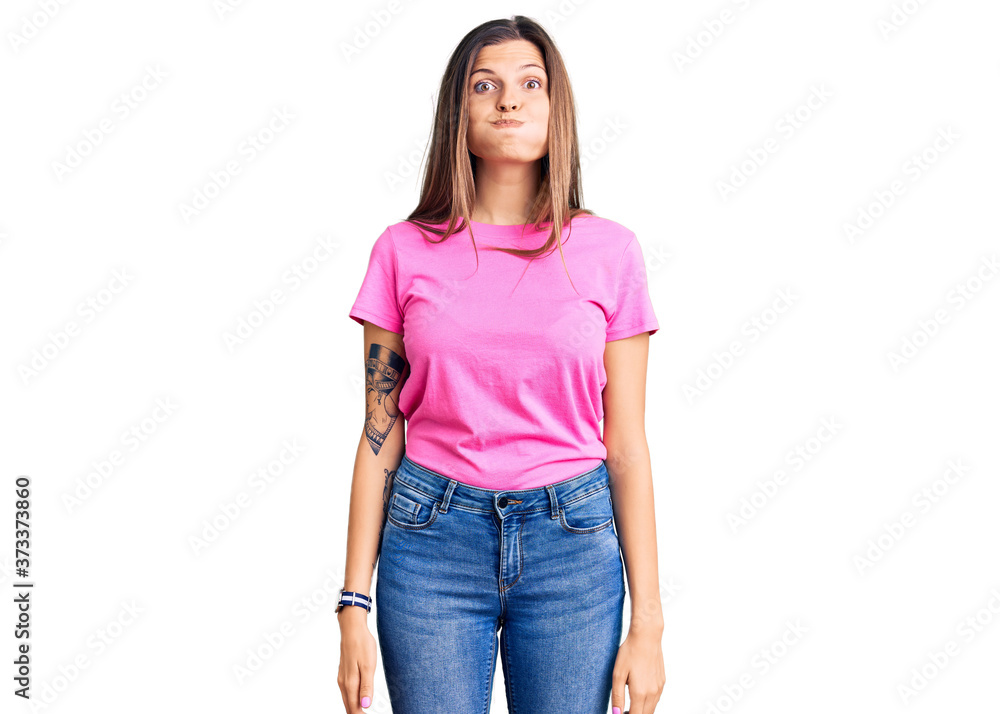 Obraz premium Beautiful caucasian woman wearing casual clothes puffing cheeks with funny face. mouth inflated with air, crazy expression.