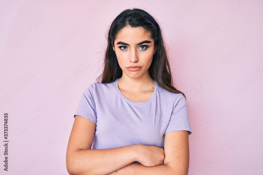 Obraz premium Brunette teenager girl wearing casual clothes skeptic and nervous, disapproving expression on face with crossed arms. negative person.