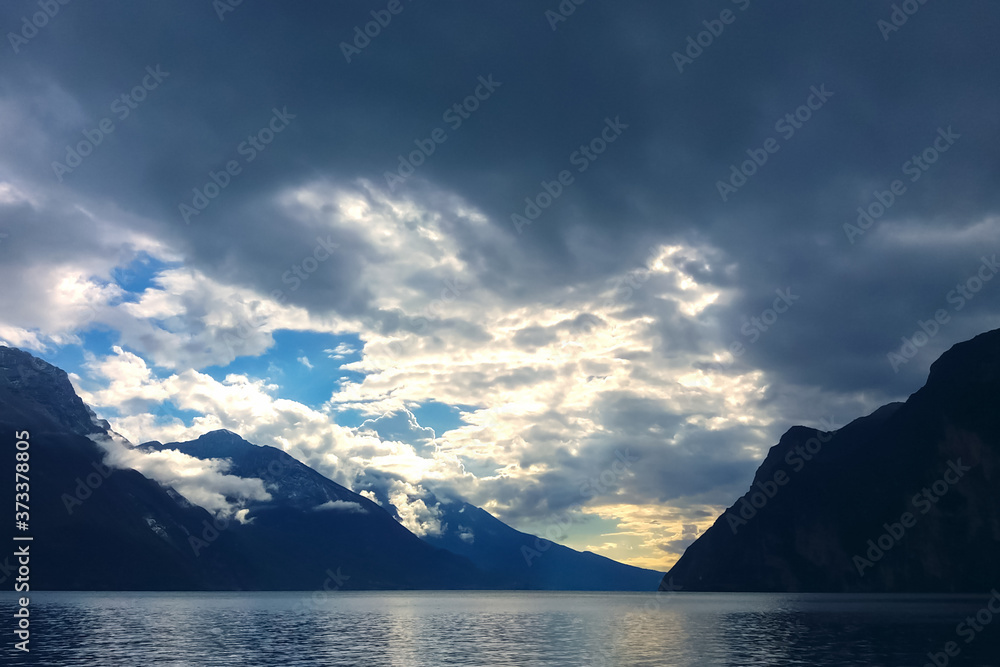 mountain lake with dramatic clouds in stormy sky at blue twilight mountain lake with dramatic clouds in stormy sky at blue twilight