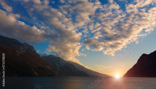 clouds over mountain lake at dawn, sunrise over beautiful mountain lake