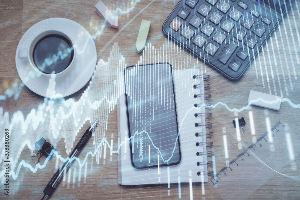 Multi exposure of forex graph hologram over desktop with phone. Top view. Mobile trade platform concept. Multi exposure of forex graph hologram over desktop with phone. Top view. Mobile trade platform concept.