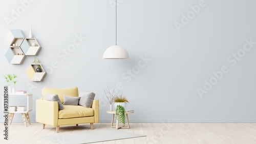 The interior has a yellow armchair on empty gray wall background.