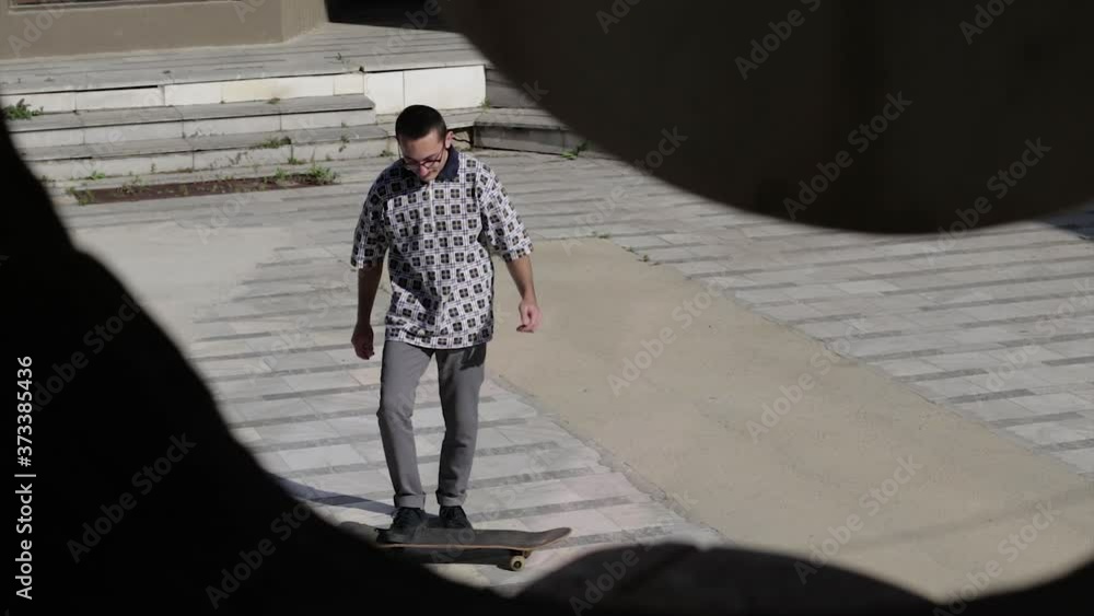 Skater Practicing Jumps or Ollie With Skateboard, Seen Through Hole Skater Practicing Jumps or Ollie With Skateboard, Seen Through Hole