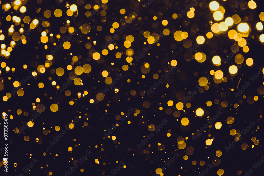Abstract gold defocused bokeh of lights in dark Abstract gold defocused bokeh of lights in dark