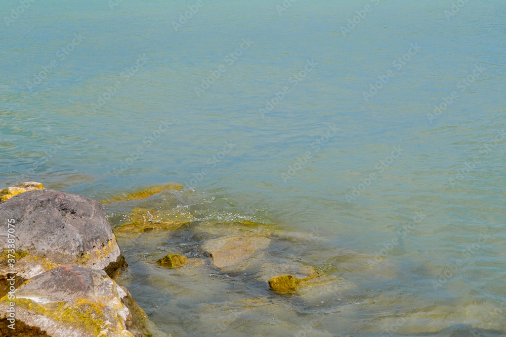 Rocky shore of Lake Balaton in Hungary. Coastline of the Hungarian Sea. Place for text, copy spase.