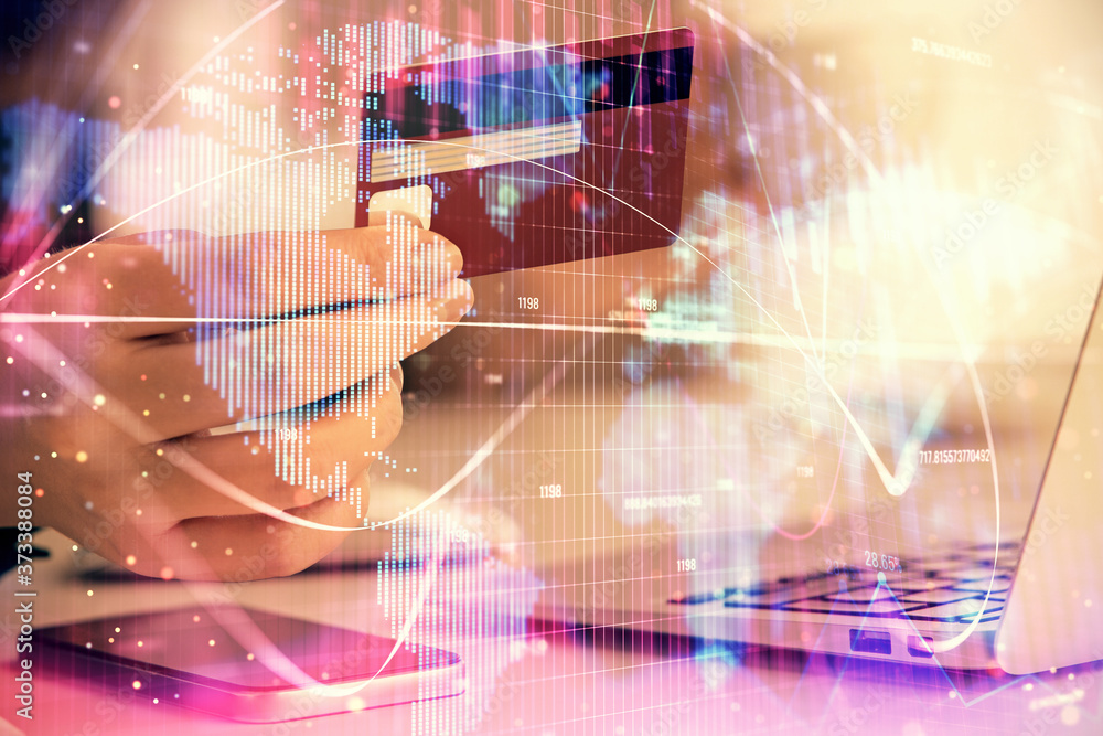 Multi exposure of woman on-line shopping holding a credit card and financial theme drawing. Business E-commerce concept. Multi exposure of woman on-line shopping holding a credit card and financial theme drawing. Business E-commerce concept.