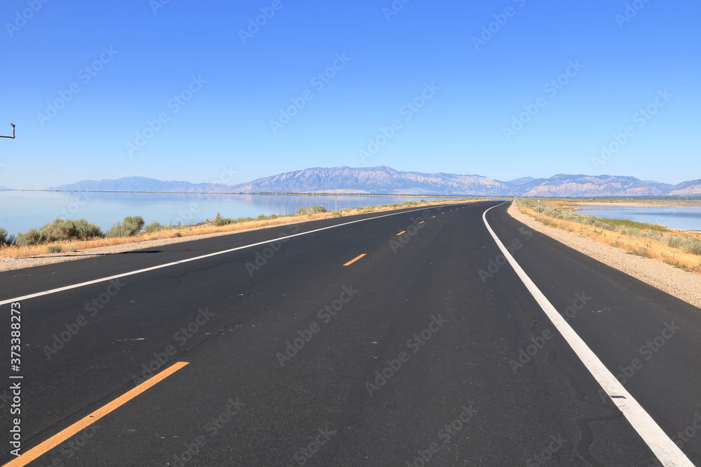 Antelope Island Causeway across the Great Salt Lake towards Wasatch Mountain Range in the East
